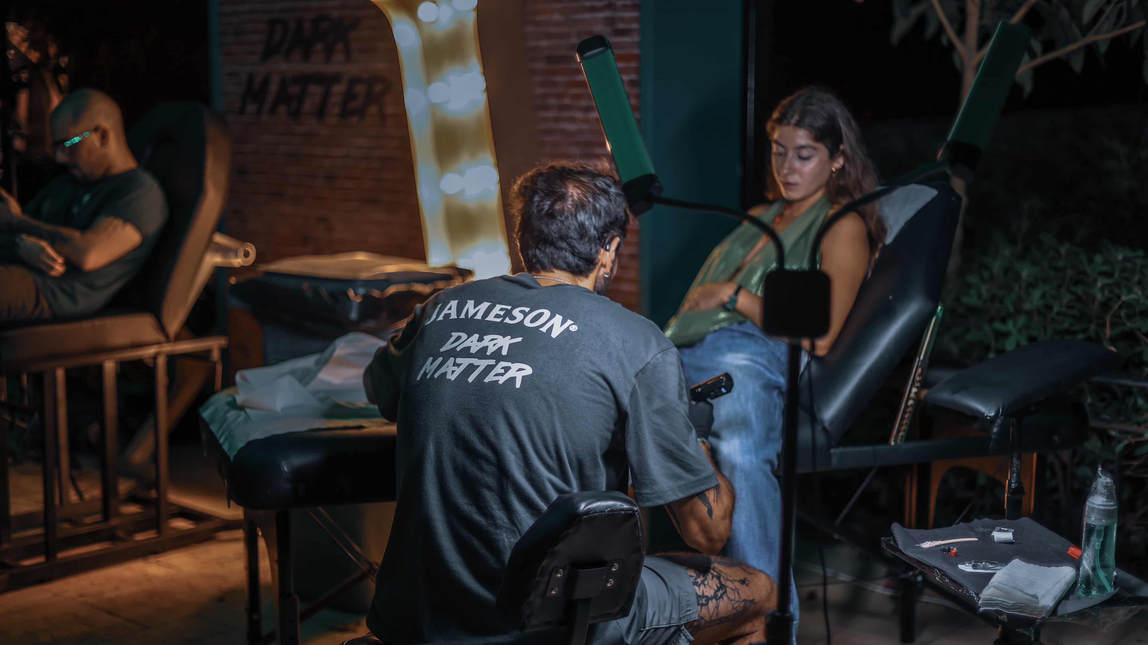 Aegis — tattooing under Jameson neon