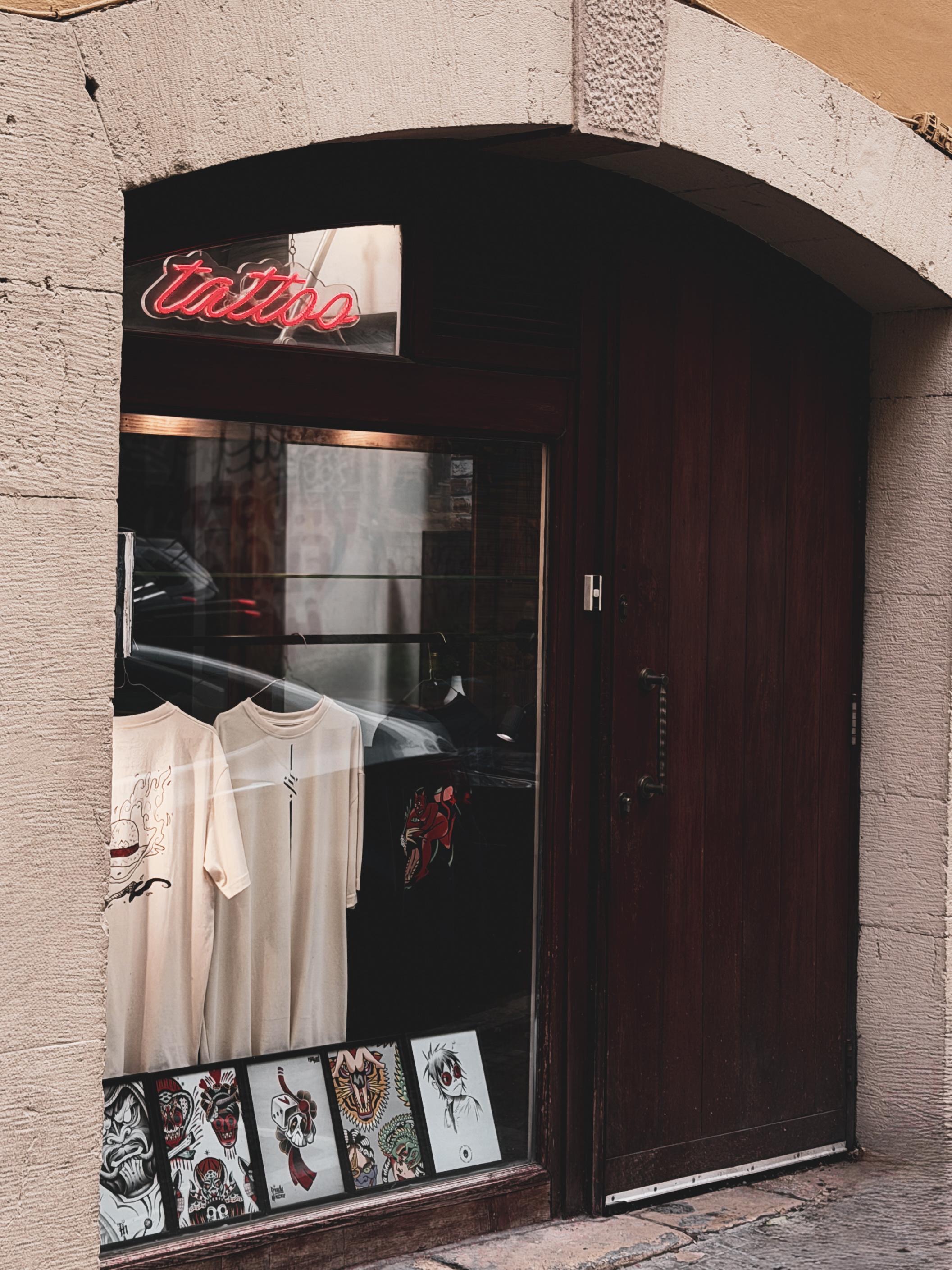 Dark Matter storefront — neon tattoo sign on Rue Gouraud